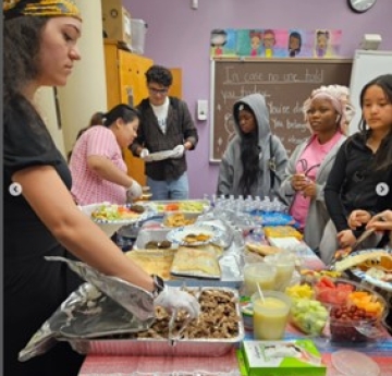 staff serving food to students